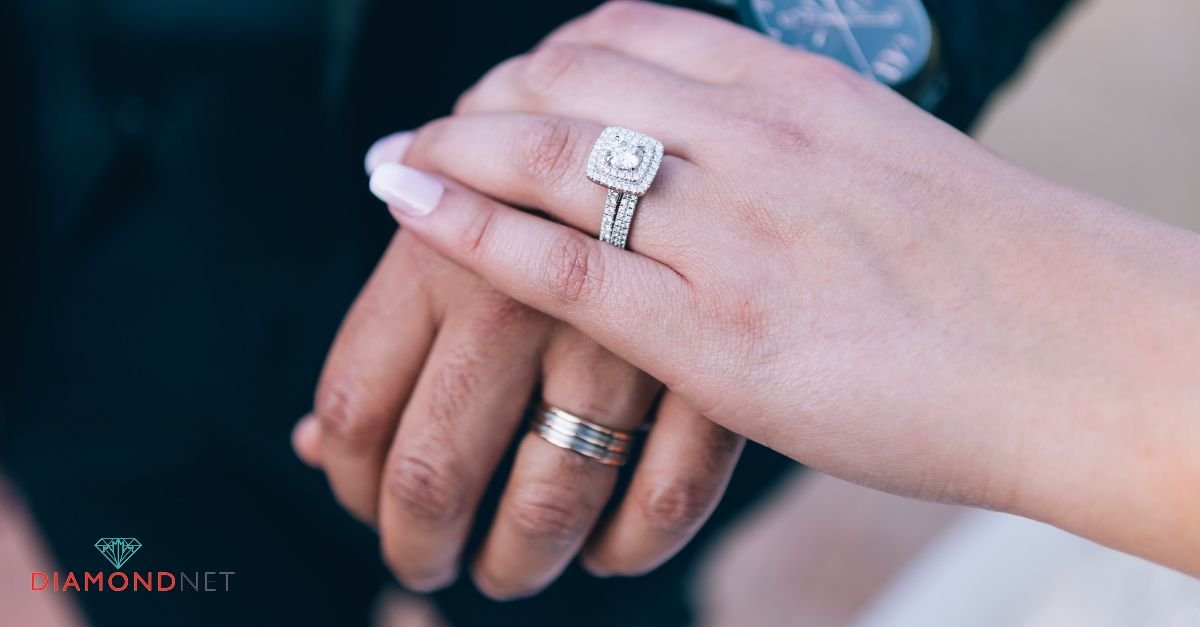  A woman's hands gently hold a wedding ring, showcasing it prominently on her ring finger