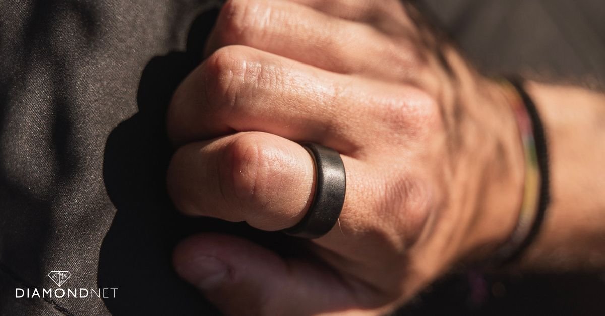 A sleek black wedding ring made of carbon fiber