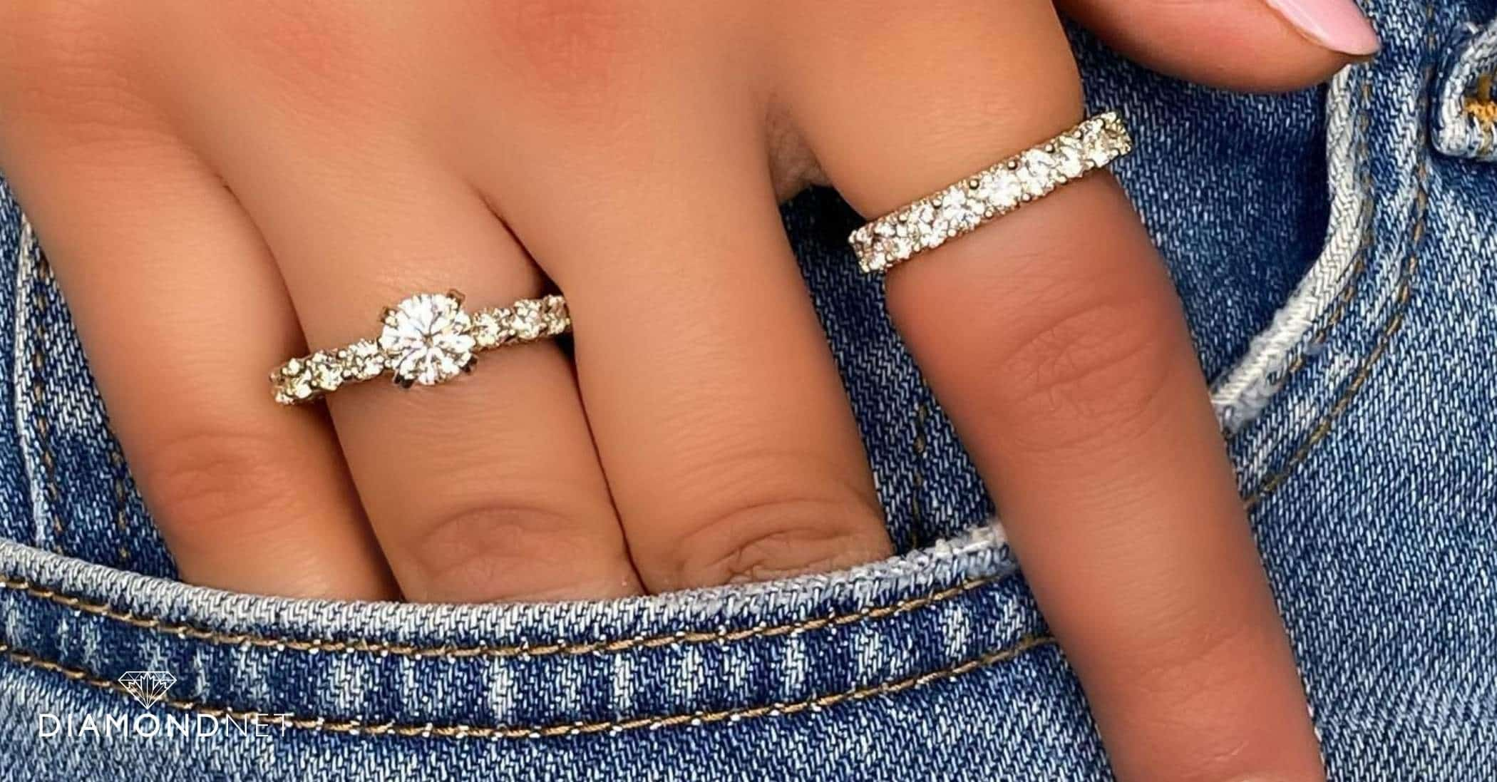 A woman's hand displaying a diamond ring, exemplifying the perfect engagement ring setting for small hands.