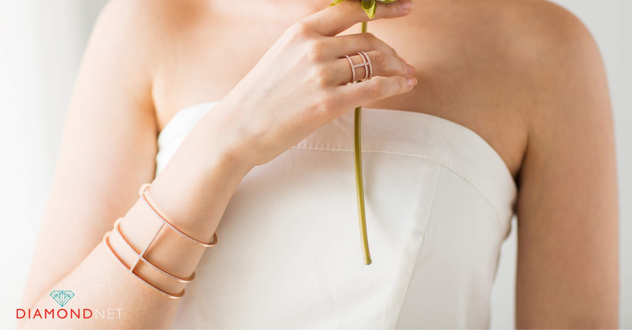 A woman displays a bracelet and diamond ring, illustrating how to style diamond jewelry for a casual look.