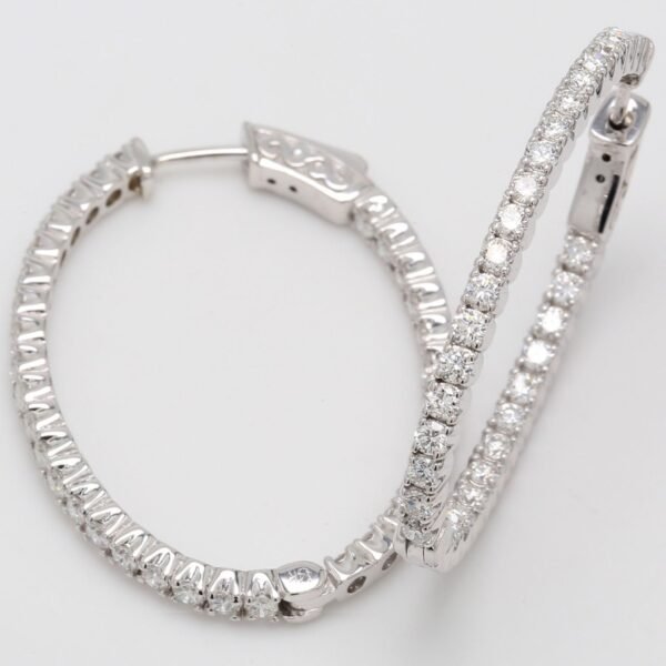 1.5' Oval shaped inside out hoop earrings with 4-prong set round diamonds.  D2.26ct.t.w.