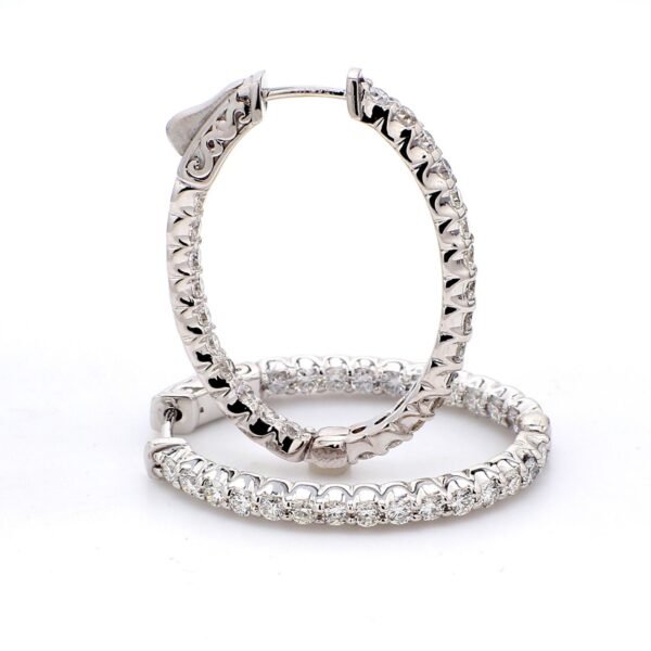 0.75' Oval shaped inside out hoop earrings with U-prong set (24) round diamonds & with special spring lock.  D0.87ct.t.w.