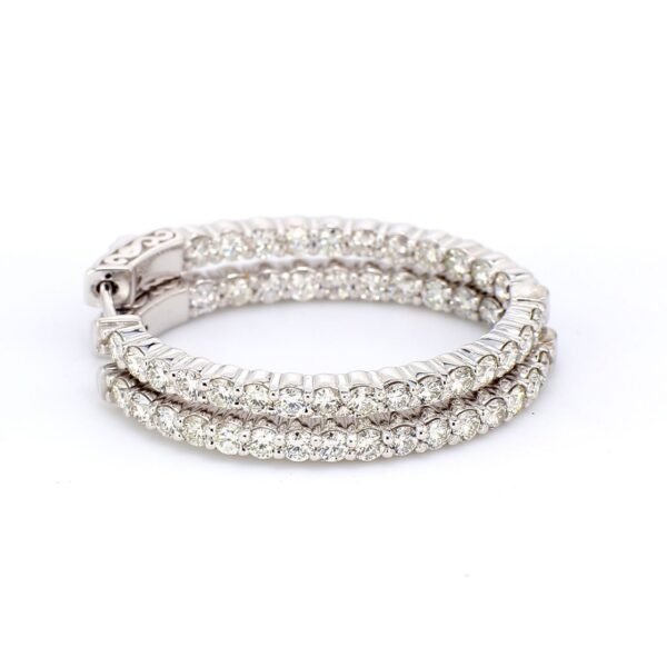 1.25' Oval shaped inside out hoop earrings with shared prong set (54) round diamonds & with special spring lock.  D2.59ct.t.w.