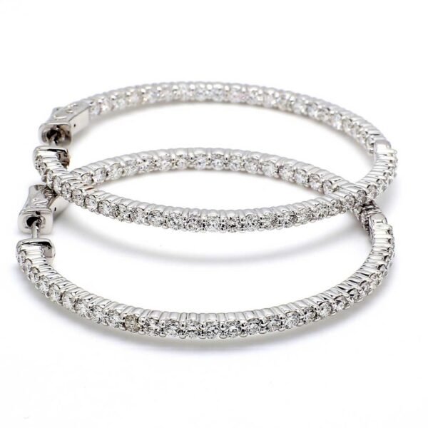 1.25' Inside out hoop earrings with shared prong set (58) round diamonds & with special spring lock.  D3.22ct.t.w.