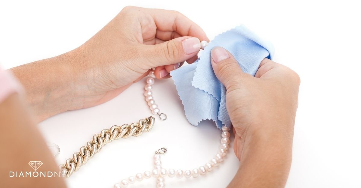A person carefully wipes a whimsical ring with a cloth, highlighting the care involved in jewellery upkeep