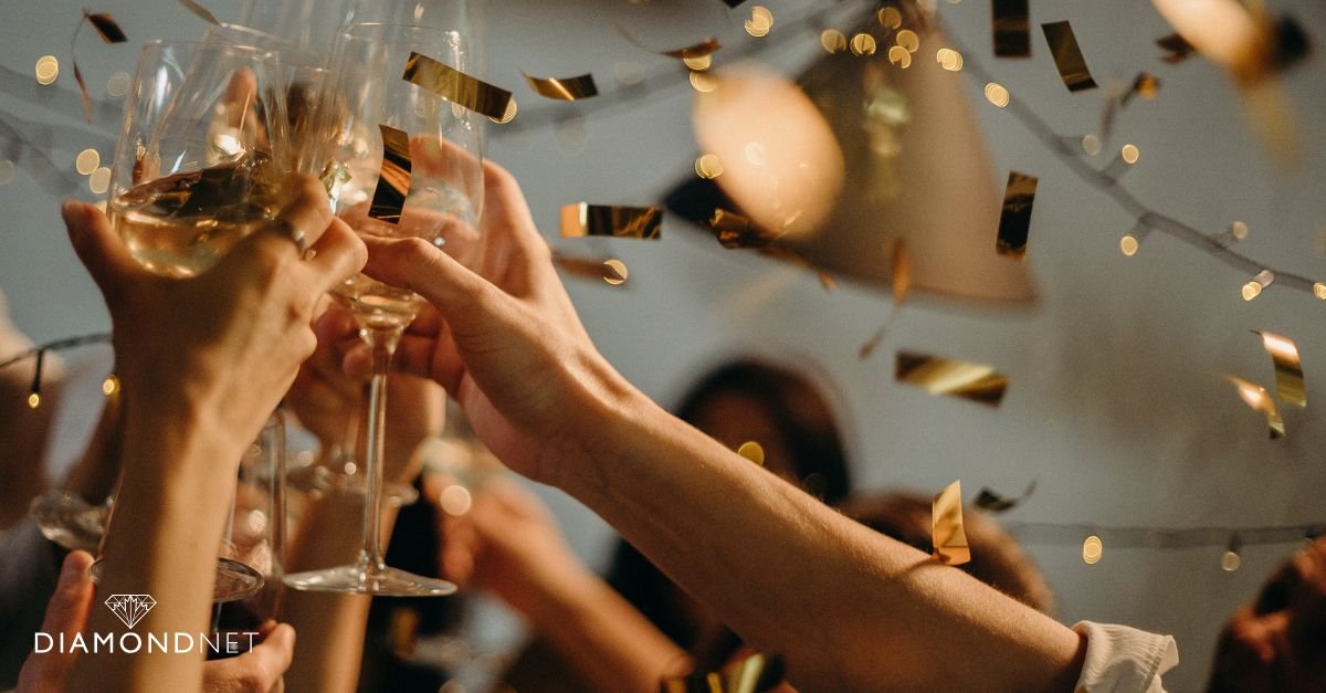 A group of friends toasting with glasses at a budget-friendly DIY engagement party dinner table