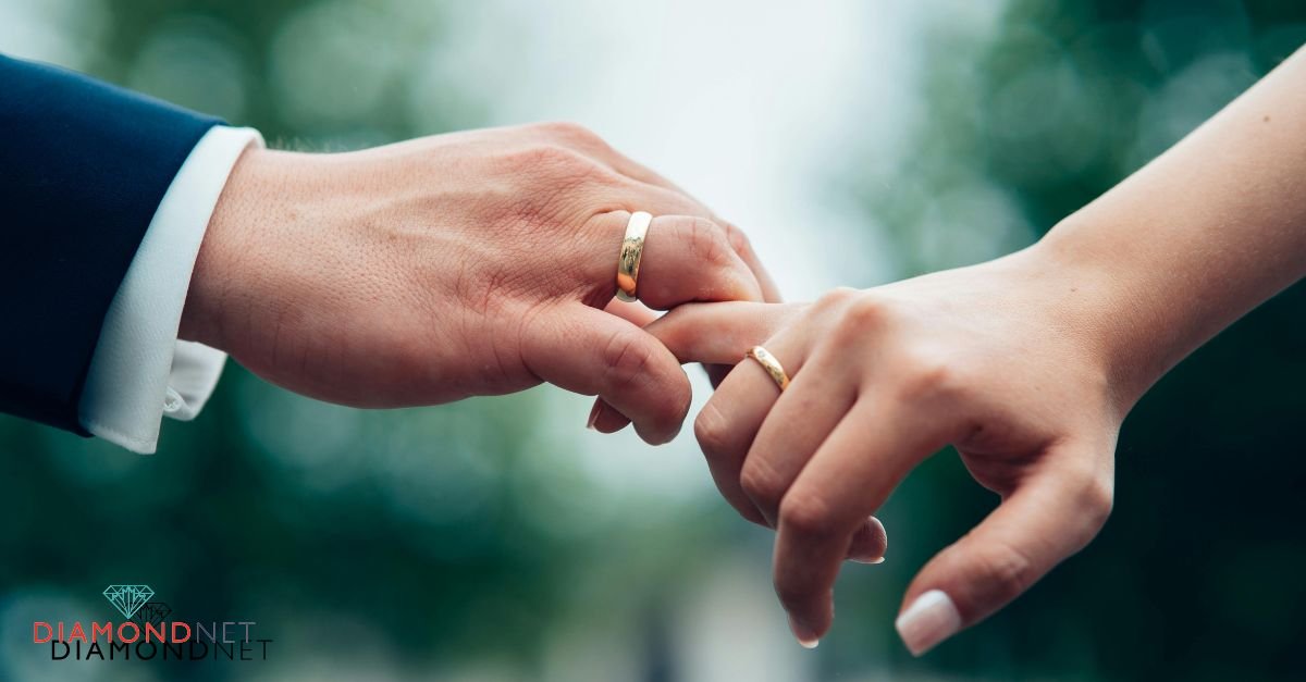 A bride and groom holding hands, showcasing their wedding rings, symbolizing their emotional readiness for marriage