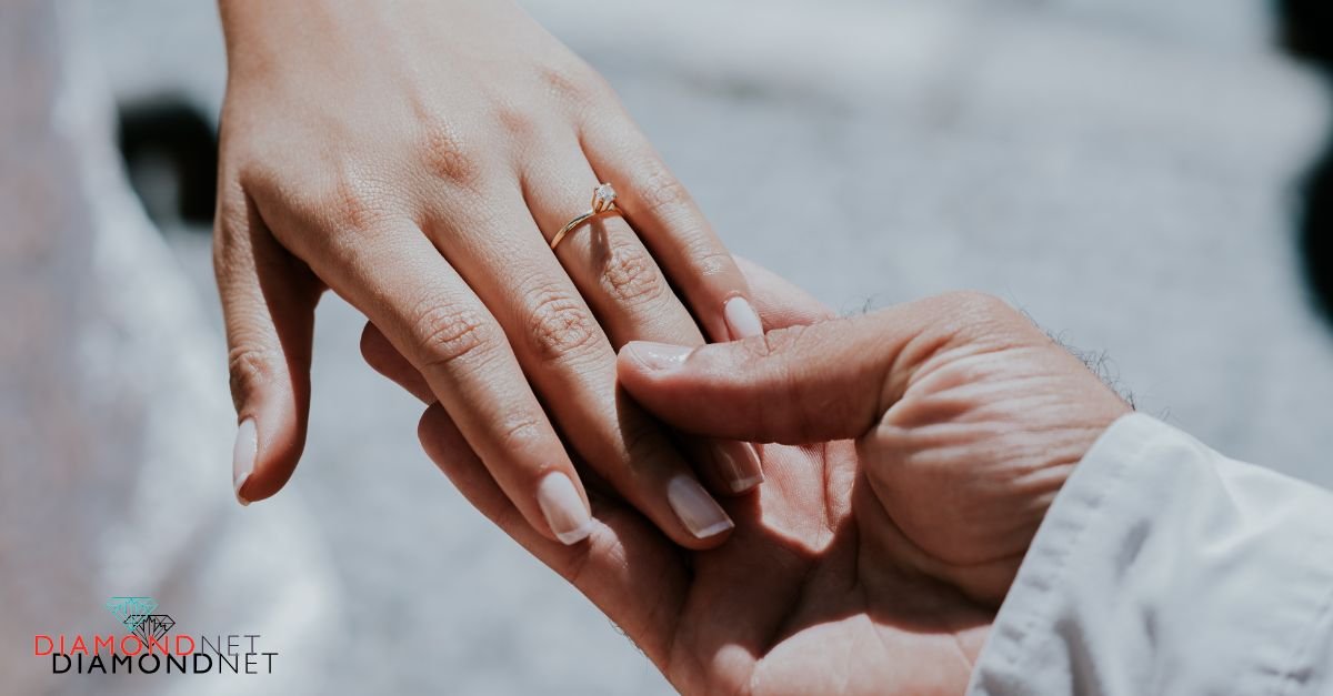 A man placing a diamond ring on a man's hand, symbolizing their engagement readiness