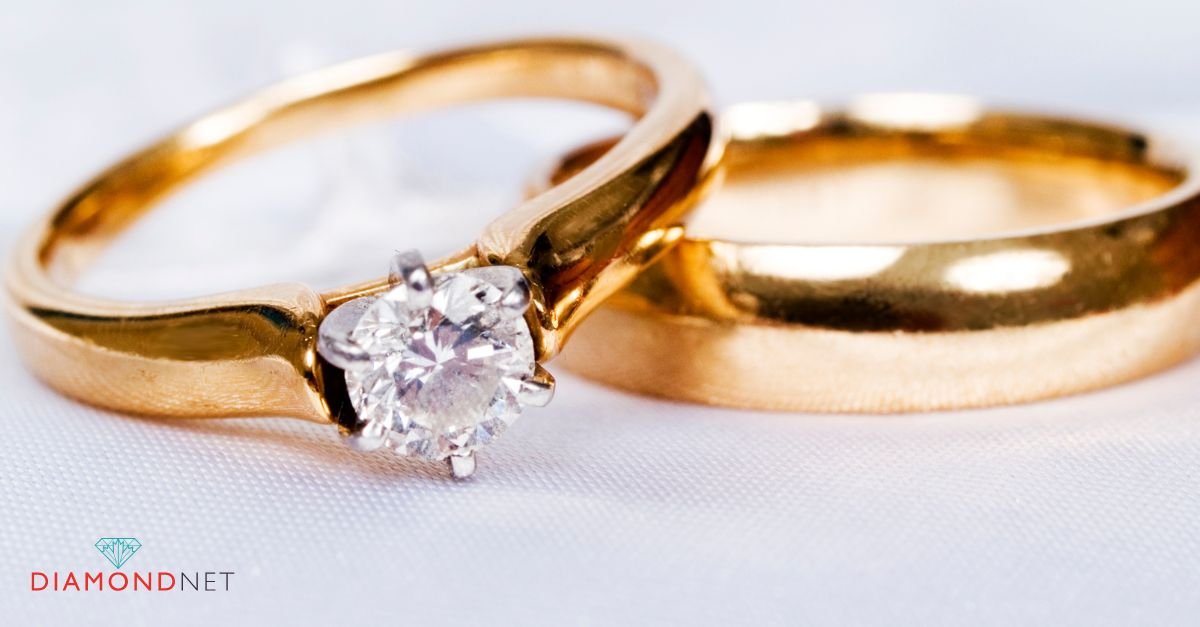 A woman's hand adorned with a bold gold engagement ring 
