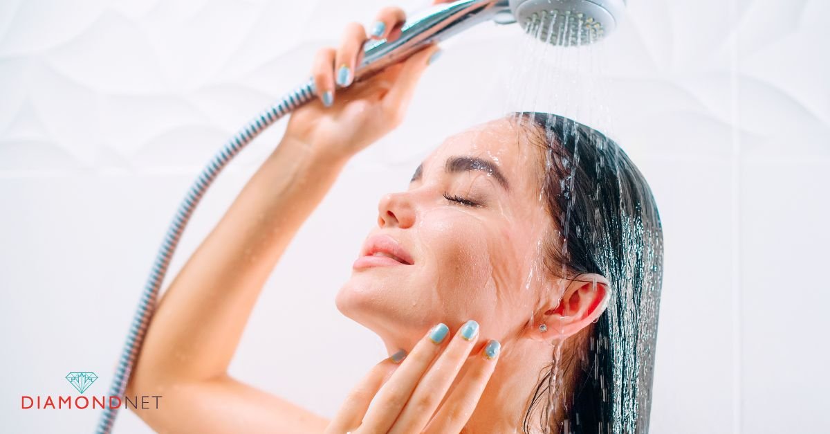 A woman with diamond earrings stands under a shower