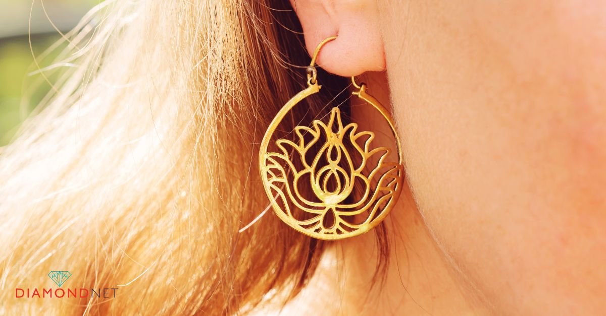 A woman holds her ear, wearing everyday diamond stud earrings that sparkle subtly