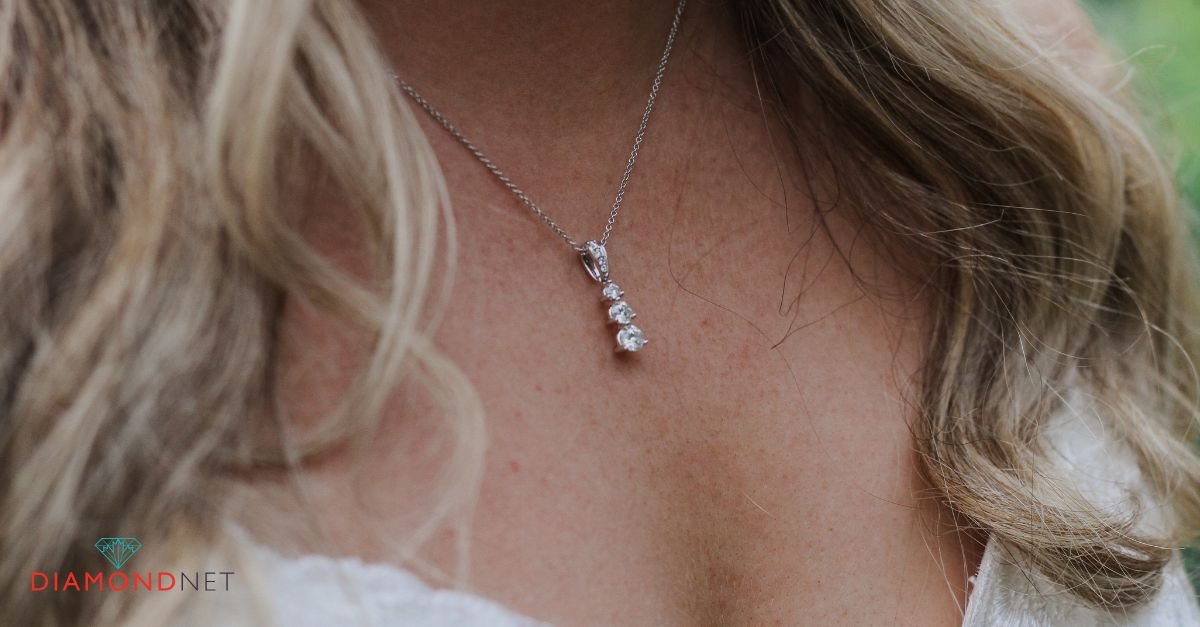 A woman wears a sparkling diamond necklace, highlighting bridal jewelry options for brides.