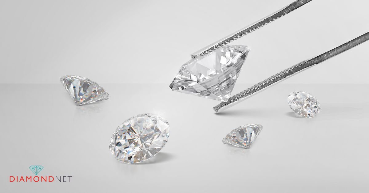 A person examines diamond earrings through a magnifying glass, demonstrating the magnification test for diamond earrings.