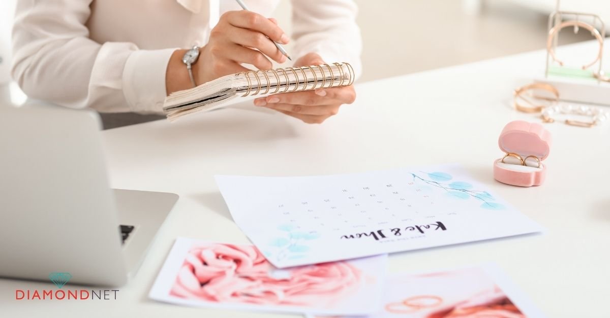 A woman's hands rest on a table with a wedding planner, indicating wedding planning activities