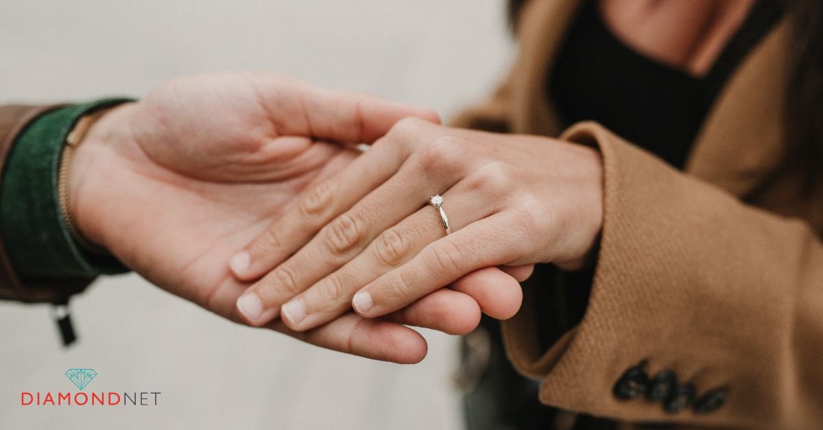 A close-up of a woman's hand displaying a sustainable diamond ring