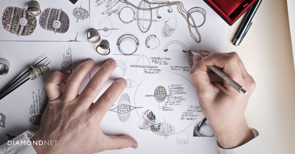 An elegant engagement ring alongside a pen on paper, representing bespoke jewelry design