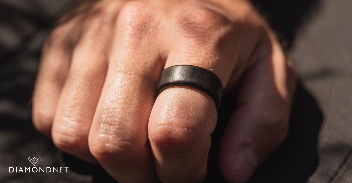 Man cleaning his black wedding ring with a soft cloth
