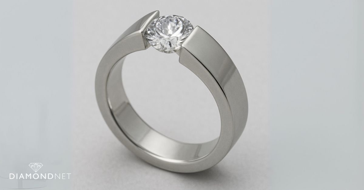 A woman viewing a modern tension-set diamond ring